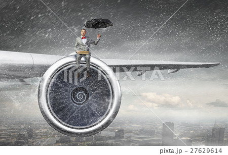 On wing of flying airplane On wing of flying airplane 27629614