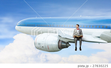 On wing of flying airplane 27630225