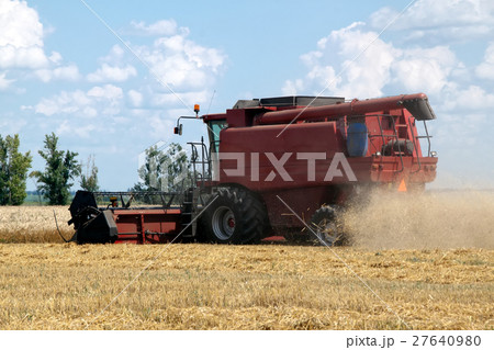 Combine harvester working on a wheat field Combine harvester working on a wheat field 27640980