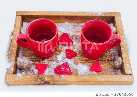 Cups with tea in snow, Valentine's day 27643050