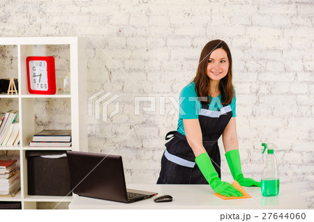 Woman Cleaner cleans office table 27644060