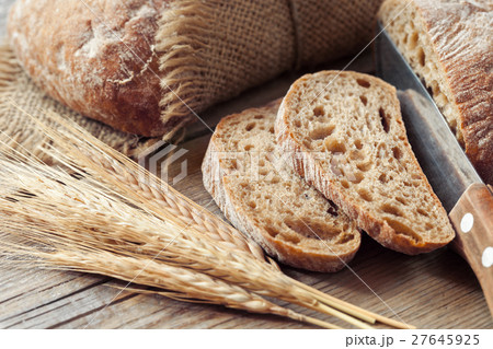 Fresh bread slice and rye ears. Fresh bread slice and rye ears. 27645925