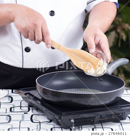 Chef putting garlic to the pan 27646011