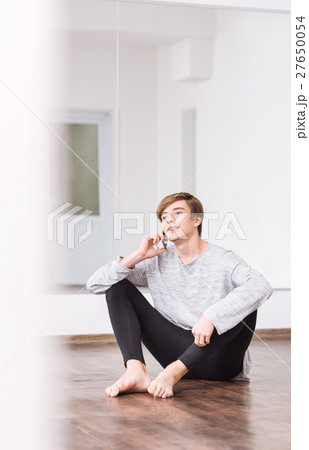 Positive nice dancer holding a cell phone 27650054