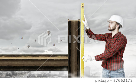 Builder checking spirit level 27662175