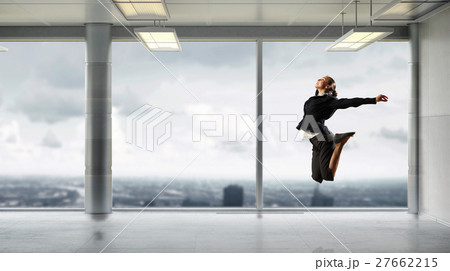 Dancing businesswoman in office Dancing businesswoman in office 27662215