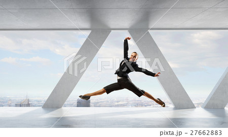 Dancing businesswoman in office 27662883