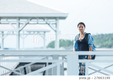 Woman wearing jeans and a denim jacket. She relax Woman wearing jeans and a denim jacket. She relax 27663190
