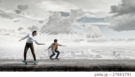 Teenagers ride skateboards Teenagers ride skateboards 27663791