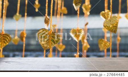 Gold pho leaves hanging on golden tree (blur image) with selected focus wood table for display your product 27664485