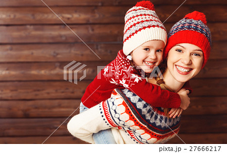 happy family mother and child girl  hugs at wooden background. 27666217