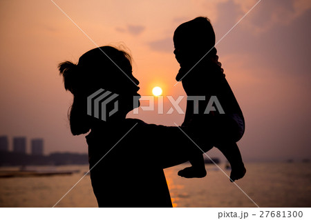 Silhouette of mother plays with her toddle Silhouette of mother plays with her toddle 27681300