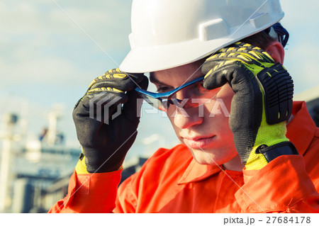 Engineer is wearing the safety goggles. Engineer is wearing the safety goggles. 27684178
