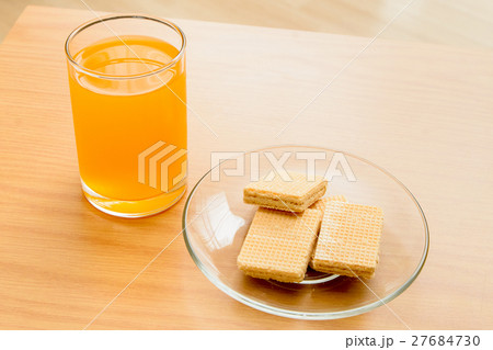 Orange juice and Wafer on the wooden table 27684730