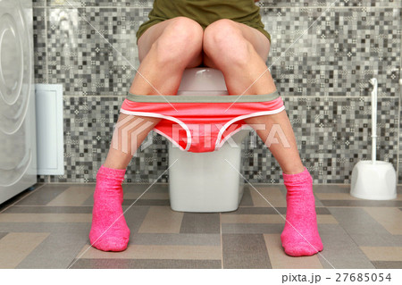 woman sits on toilet bowl 27685054