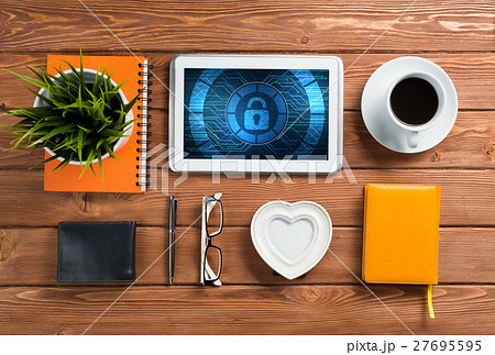 Web security and technology concept with tablet pc on wooden table 27695595