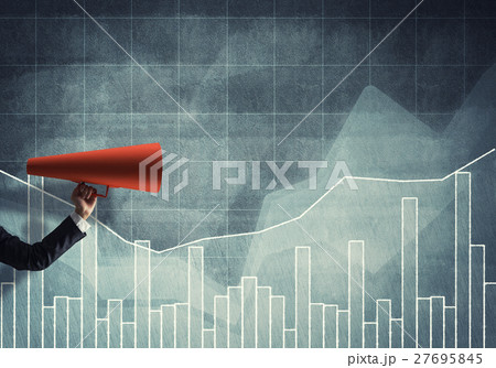 Hand of businesswoman holding red paper trumpet against graphs background Hand of businesswoman holding red paper trumpet against graphs background 27695845