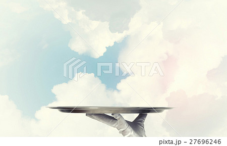 Waiter holding empty silver platter ready for product or item placement 27696246