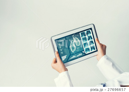 Close of female doctor hands working with tablet pc computer Close of female doctor hands working with tablet pc computer 27696657