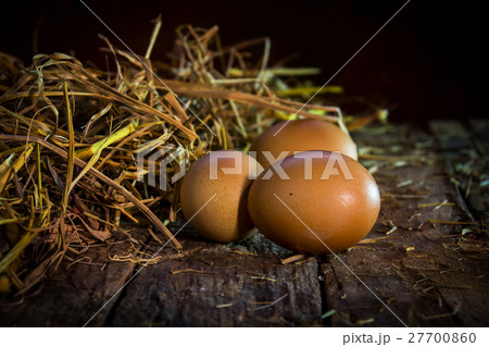 still life eggs in straw on wood background still life eggs in straw on wood background 27700860