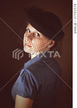 Portrait of sad woman in hat with veil on funeral. Portrait of sad woman in hat with veil on funeral. 27701578