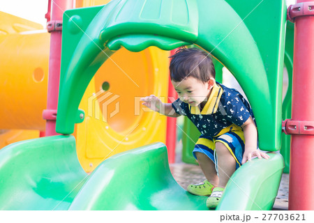 Little Asian kid playing slide at the playground 27703621
