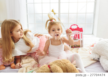 Happy girls playing in bedroom Happy girls playing in bedroom 27704474