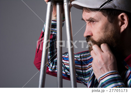Man with beard a tripod thoughtfully 27705173