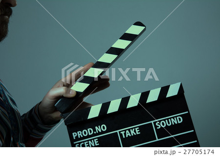 Man with clapperboard cinema 27705174