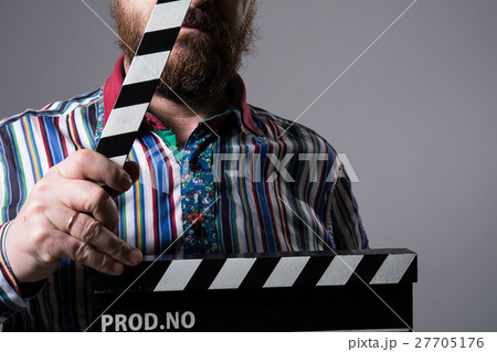 Man with clapperboard cinema 27705176