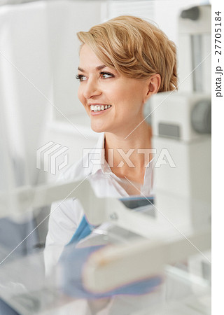 Smiling female doctor beside devices Smiling female doctor beside devices 27705184