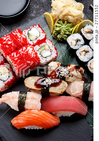Sushi set on a stone plate and concrete background Sushi set on a stone plate and concrete background 27711552