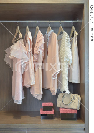 Sweet pastel blouses are hanging in open wardrobe Sweet pastel blouses are hanging in open wardrobe 27711635
