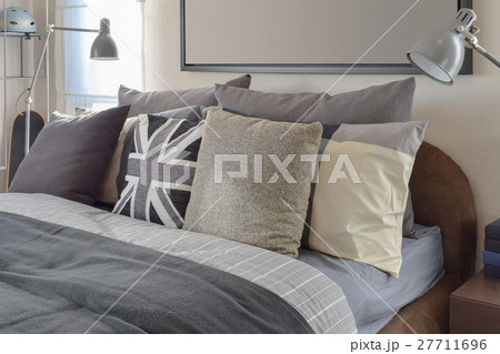 modern bedroom with gray pillow and lamp on table 27711696