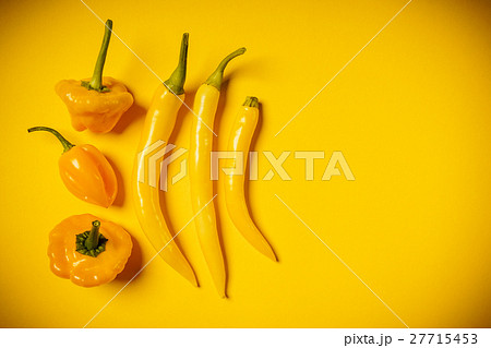 small peppers on a yellow background small peppers on a yellow background 27715453