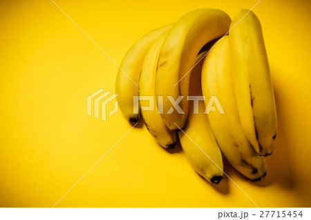 bunch of bananas on a yellow background bunch of bananas on a yellow background 27715454