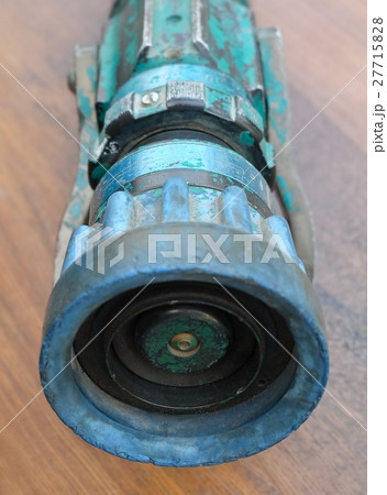 Old Vintage Firehose Nozzle on Wooden Table Old Vintage Firehose Nozzle on Wooden Table 27715828