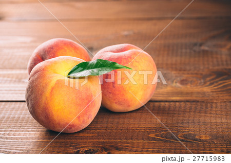 Fresh beautiful fruit peaches on wooden background Fresh beautiful fruit peaches on wooden background 27715983
