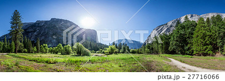 Meadow and trees surrounded by rocky mountains Meadow and trees surrounded by rocky mountains 27716066