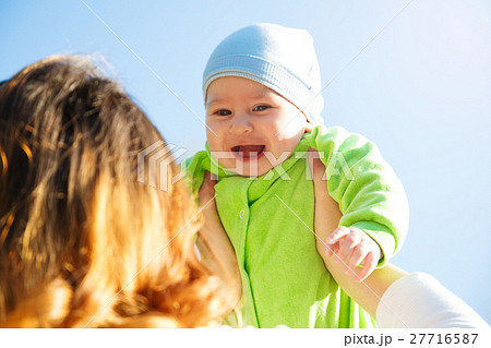 Mother Playing with Her Smiling Baby in Hands 27716587