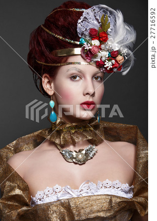 Young girl in baroque gold attire. Historical look 27716592