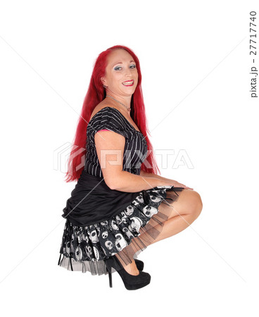 Woman kneeling in black dress. Woman kneeling in black dress. 27717740