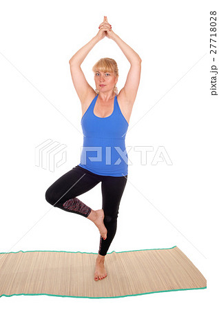 Yoga trainer standing on one leg. Yoga trainer standing on one leg. 27718028
