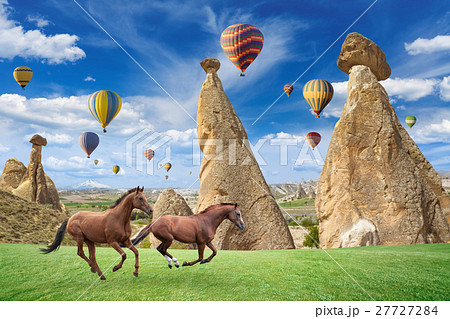 Hot air balloon and horses running in Cappadocia Hot air balloon and horses running in Cappadocia 27727284