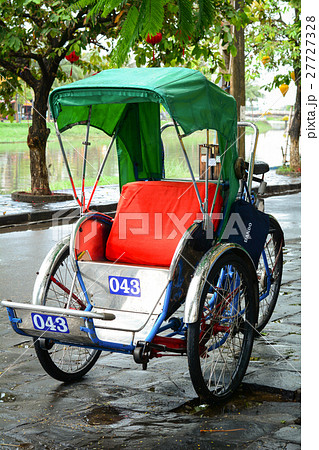 Cyclo (rickshaw) on street in Hoi An, Vietnam 27727328