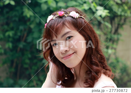 Young pretty Asian woman with flower headband. Young pretty Asian woman with flower headband. 27730872