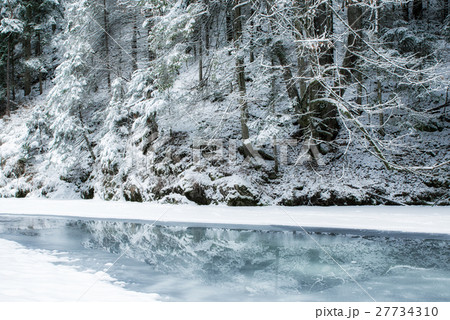 Frozen river in winter forest 27734310