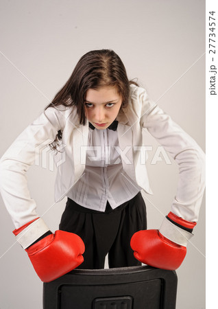 Young angry businesswoman in boxing gloves 27734574