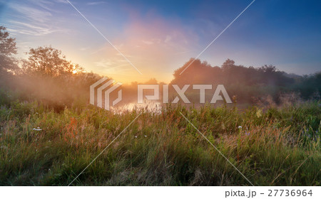 Summer misty sunrise on the river. Foggy river Summer misty sunrise on the river. Foggy river 27736964