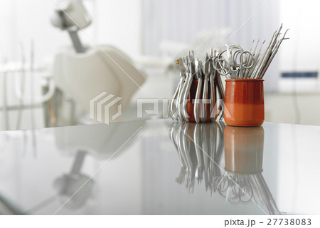 Cool iron dental instruments are on table of 27738083